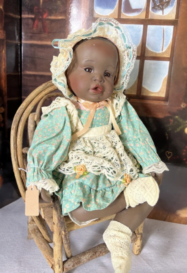 Image of the Homestead Heirloom Porcelain Doll by Yolanda Bellows, a 15-inch collectible with delicate porcelain craftsmanship, dressed in its original vintage outfit.